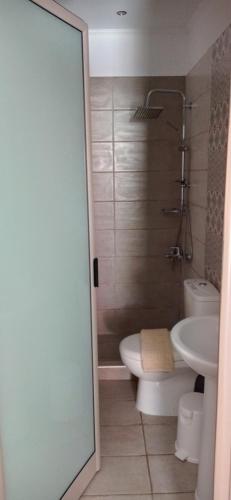 a bathroom with a toilet and a sink at Ethra luxury studios in Asprovalta