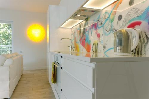 a kitchen with a counter with a toaster on it at Zebra Baltic in Świnoujście