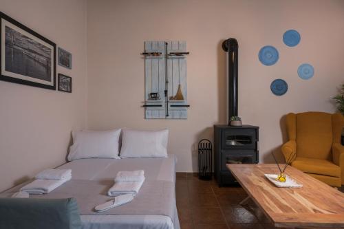 a bedroom with a bed and a table and a chair at Iosif de Home in Kournás
