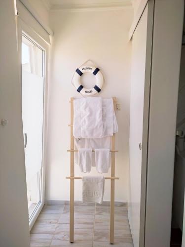 a towel rack with towels on it in a bathroom at Appartements Dominique, with private terrace in Supetarska Draga