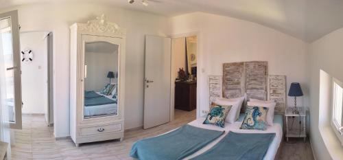 a bedroom with a bed and a large mirror at Appartements Dominique, with private terrace in Supetarska Draga