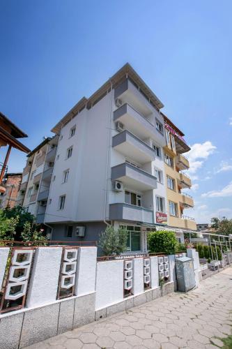 a tall apartment building with lots of boarded up windows at Family Hotel Ambrozia in Sandanski