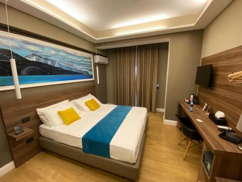 a bedroom with a bed and a desk and a computer at 7th Floor Suite in Naples