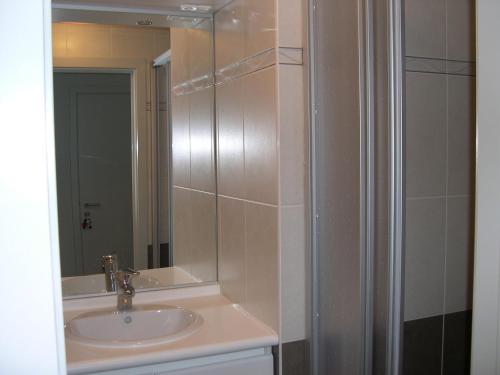 a bathroom with a sink and a mirror at Appartement Koksijde in Koksijde