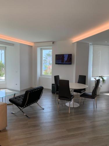 a living room with a table and chairs at Miramare The Palace Resort in Sanremo