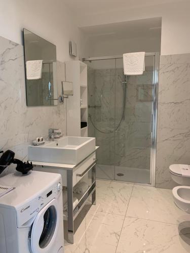 a bathroom with a washing machine and a sink at Miramare The Palace Resort in Sanremo