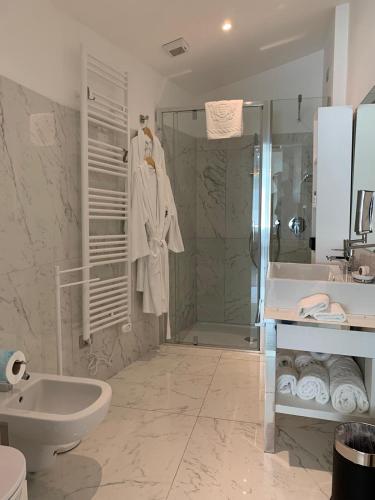 a bathroom with a shower and a toilet and a sink at Miramare The Palace Resort in Sanremo