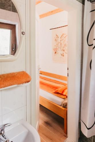 a bathroom with a sink and a bunk bed at Behív-Lak in Medişoru Mic