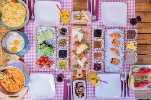 a table with plates of food on a pink checked table cloth at Kassandra Boutique Hotel in Oludeniz