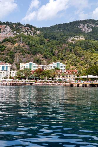 a large body of water with a town on a mountain at Grand Ring Hotel in Beldibi