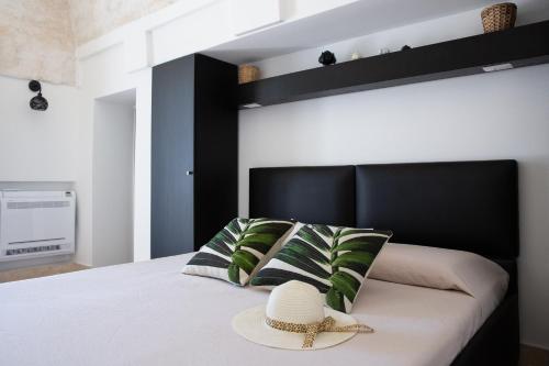 a bedroom with a bed with a hat on it at Lamia Petricore Ostuni in Ostuni