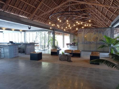 a large room with a lobby with a table and chairs at Casa Beach Hotel "Casa Del Mar" in Jambiani
