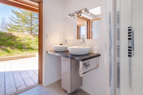 a bathroom with two sinks and a mirror at AUx SPORTS D HIVER in Courchevel