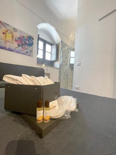 a bedroom with a bed and two bottles on the floor at Il Telescopio in Noto