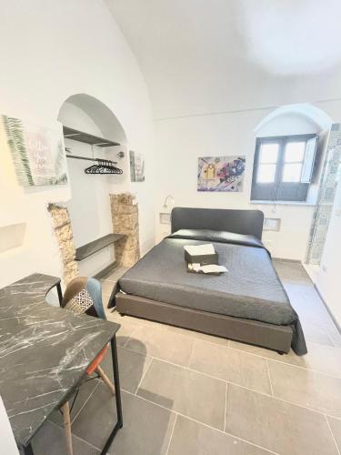 a bedroom with a bed and a table in it at Il Telescopio in Noto