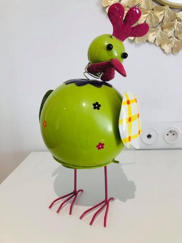 un canard vert en caoutchouc est assis sur une table dans l'établissement Maison de ville, 2ch, La Petite Aure, à Bayeux