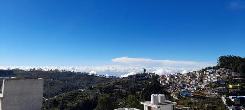a view of a city from the top of a mountain at B2B Home Stay in Kodaikānāl