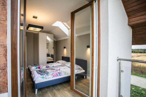 a room with two beds and a mirror at Apartamenty przy Winnicy in Busko-Zdrój