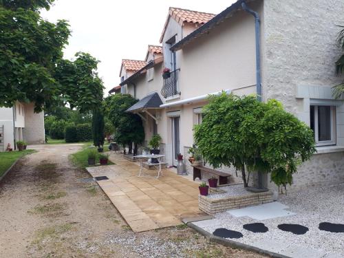 a house with a patio in front of it at Gite Amanala Poitou in Saint-Genest-dʼAmbière