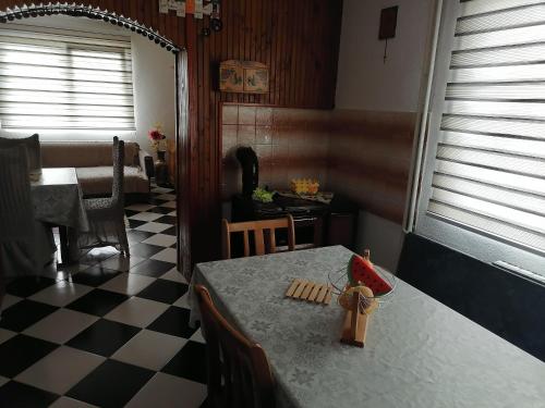 a dining room with a table and a checkered floor at Villa Shine Apartment 1 in Struga