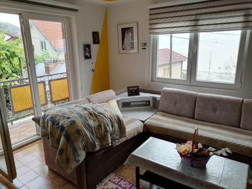 a living room with a couch and a table at Villa Shine Apartment 1 in Struga