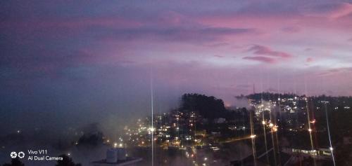 a view of a city at night with lights at B2B Home Stay in Kodaikānāl