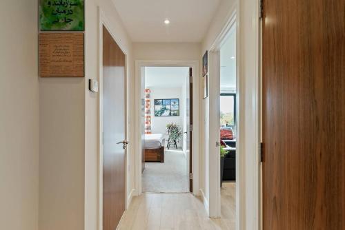 a hallway with a door leading to a room at 1-Bed Spacious Flat, North London, 15 Minutes to Central in New Southgate