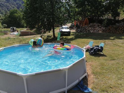 a couple of people in a swimming pool at Vila Jelena in Crni Vrh
