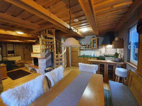 a living room with a table and a fireplace at Chalet Klara in Resnik