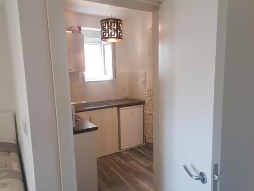 a small kitchen with a sink and a window at Natasa in Zvezdara