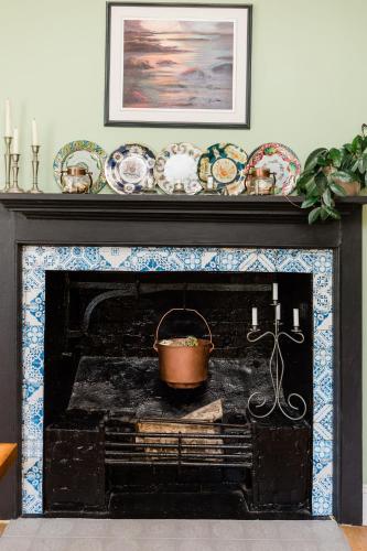 a fireplace with a pot on top of it at Willow House Inn B&B in Pictou