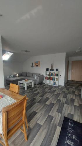 a living room with a couch and a table at Ferienwohnung Krabbe im Haus-Neuharlingersiel in Neuharlingersiel