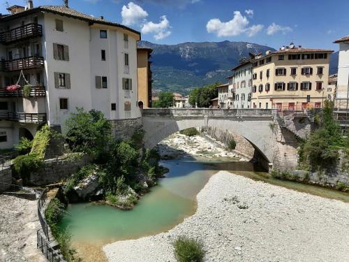 a bridge over a river in a city with buildings at DOLCE DORMIRE in Rovereto