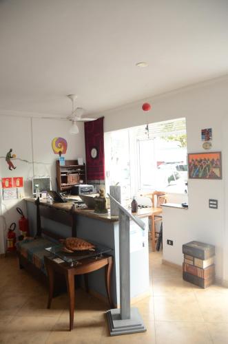 a kitchen with a counter and a table in a room at Hotel Iracemar - Econômico in Guarujá