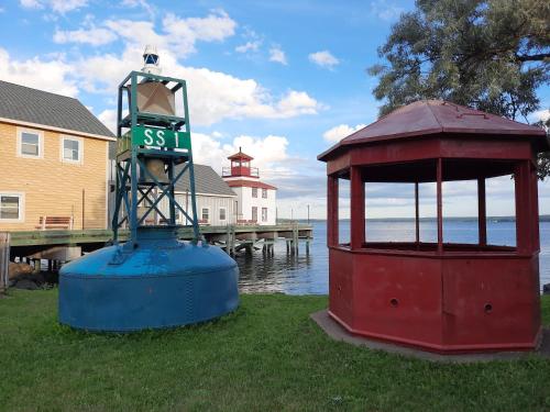 a street sign sitting next to a dock with a clock tower at Willow House Inn B&B in Pictou