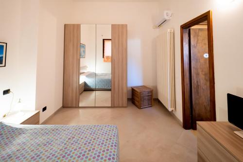 a bedroom with a bed and a large mirror at Veroalex in Abbadia Lariana