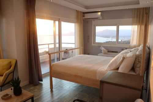 a bedroom with a bed with a view of the ocean at 360° View Suites Cos in Neapoli Voion