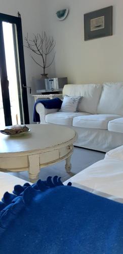 a living room with a couch and a coffee table at Hannas Paradise - Villa Hanna in Skafidia
