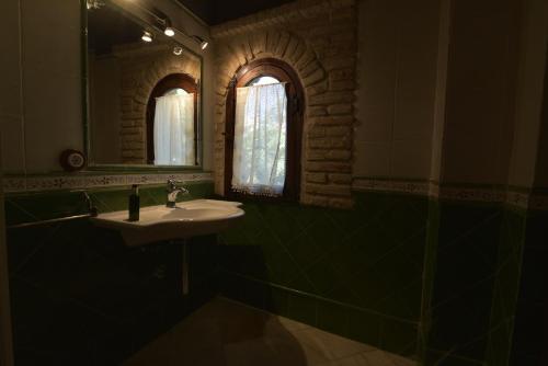 a bathroom with a sink and a mirror at Casa Palacio el Caballero de Malta in Úbeda
