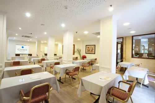 a dining room with white tables and chairs at Centrum Hotel - City Center in Nicosia