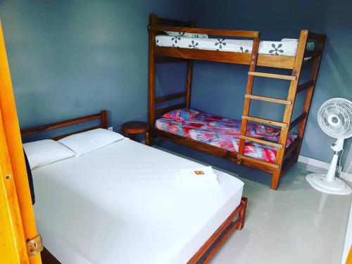 a room with two bunk beds and a ladder at La Orquidea in Mariquita