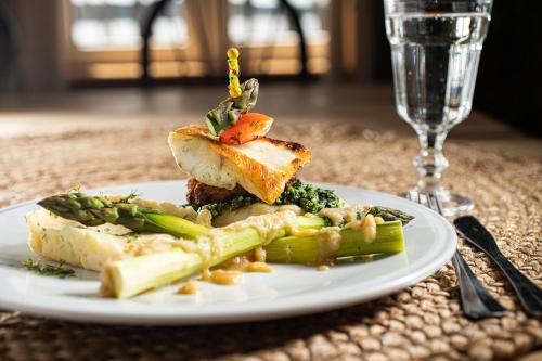 a plate of food on a table with a glass at Hotel Ukiel Wellness & SPA in Olsztyn