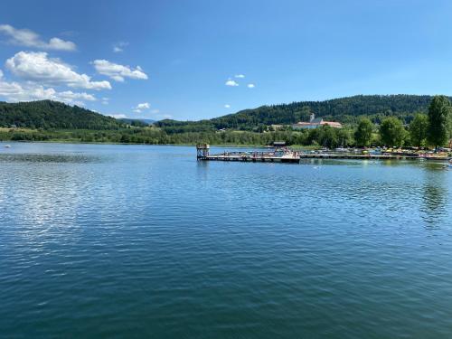 a large lake with a dock in the middle of it at Golf Residenz Längsee in Sankt Georgen am Längsee