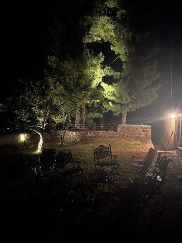 a group of chairs in a field at night at The Generals Inn in Bhurban