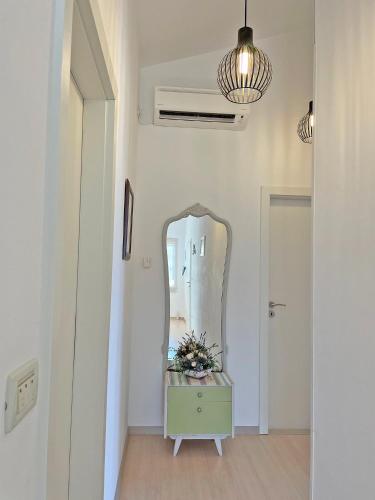 a dressing room with a mirror and a dresser at Studio Apartments Andrijana in Mlini