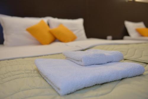 two towels sitting on top of a bed at Apartmani Tomić in Kladovo
