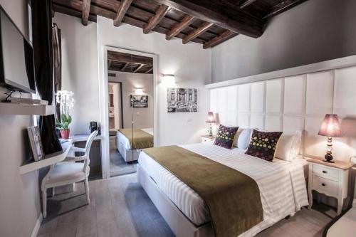 - une chambre avec un grand lit blanc et un bureau dans l'établissement Corso Suite 107 Rooms Wellness & Spa, à Rome