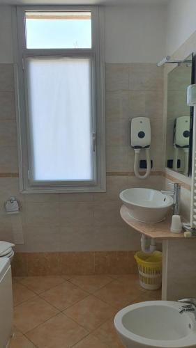 a bathroom with a sink and a window at Hotel Laguna Residence in Marghera