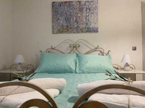 a bedroom with a green bed with two chairs at "Stalia" beach house in Vári