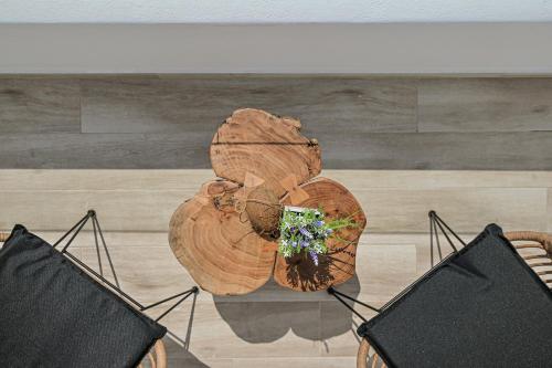 a wooden table with a plant on top of it at Marine Dream in Plaka